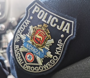Emblemat Wydziału Ruchu Drogowego Komedy Miejskiej Policji w Łomży.