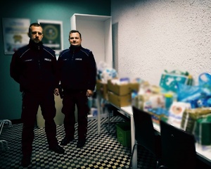 Dwóch policjantów stoi obok zakupionych rzeczy
