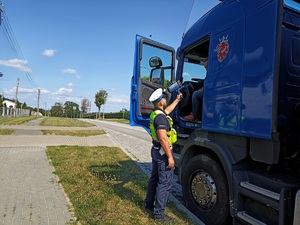 policjant kontroluje pojazd ciężarowy