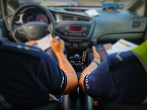 policjanci w radiowozie piszący mandat